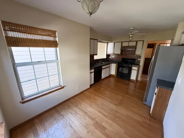a view of kitchen with furniture and wooden floor