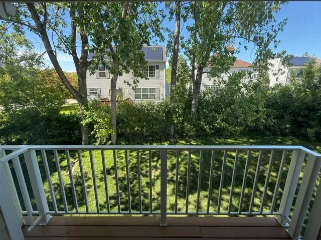 a wooden deck with trees in front of it