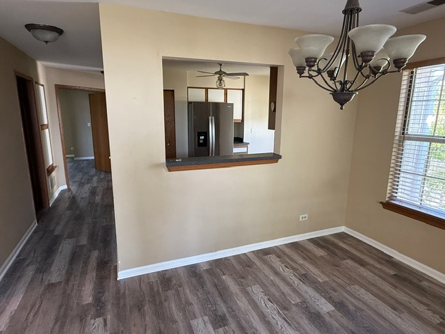 16 Tyler Court, Unit B Streamwood, IL 60107 - Photo 5 of 20 a view of a livingroom with wooden floor and chandelier