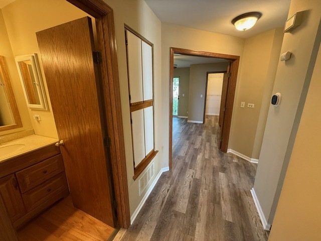 16 Tyler Court, Unit B Streamwood, IL 60107 - Photo 6 of 20 a view of a hallway with wooden floor and stairs