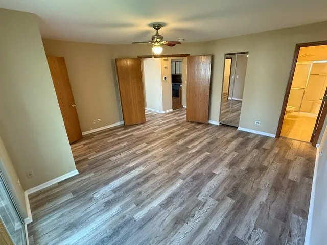 a view of a room with wooden floor and staircase