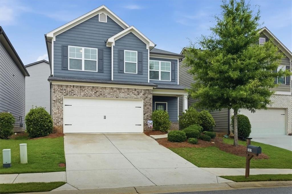 585 Summit Point Canton, GA 30114 - Photo 1 of 30 a front view of a house with a yard and garage