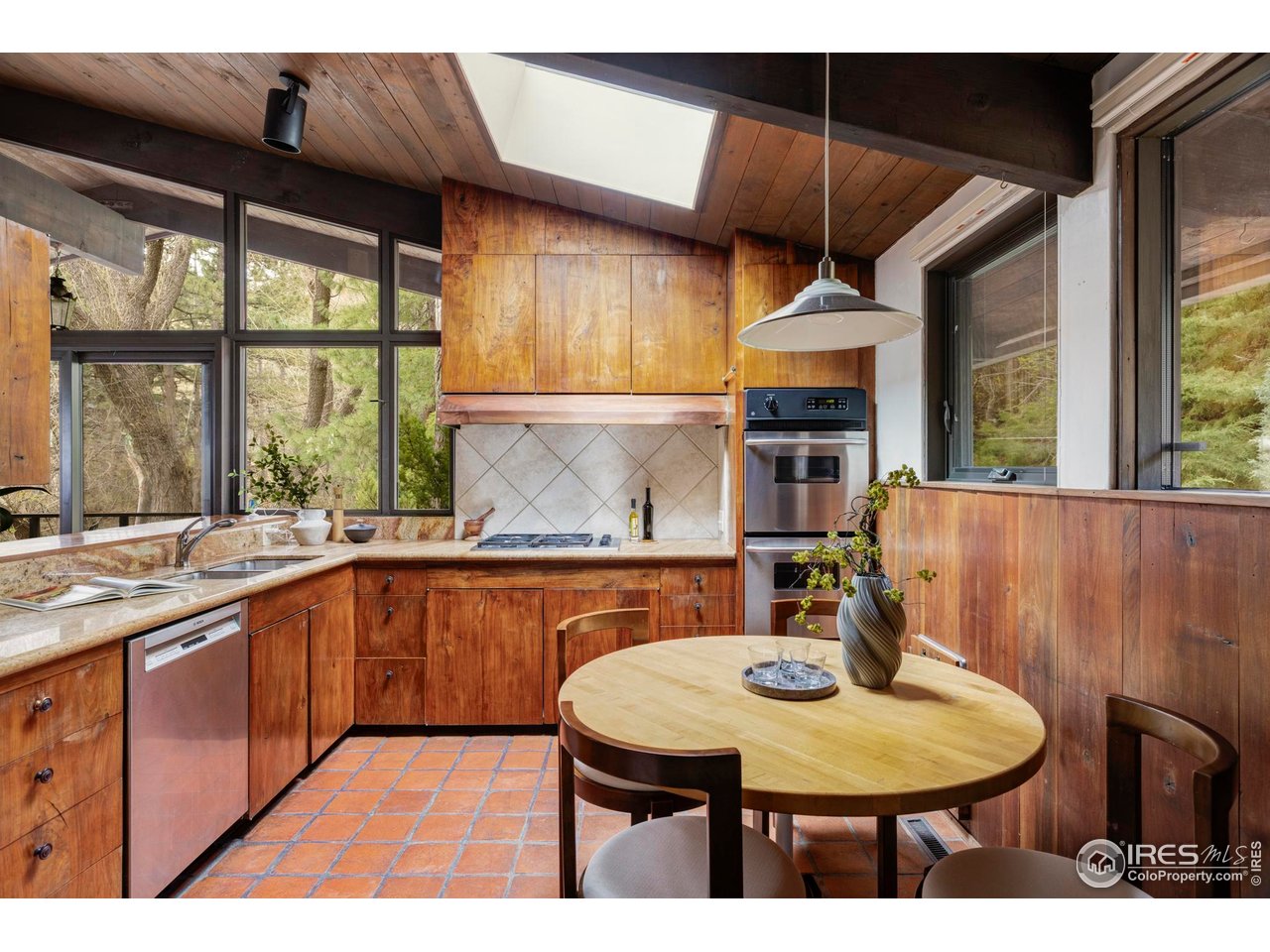 705 Willowbrook Road Boulder, CO 80302 - Photo 11 of 34 a kitchen with stainless steel appliances granite countertop a sink a stove a dining table and chairs