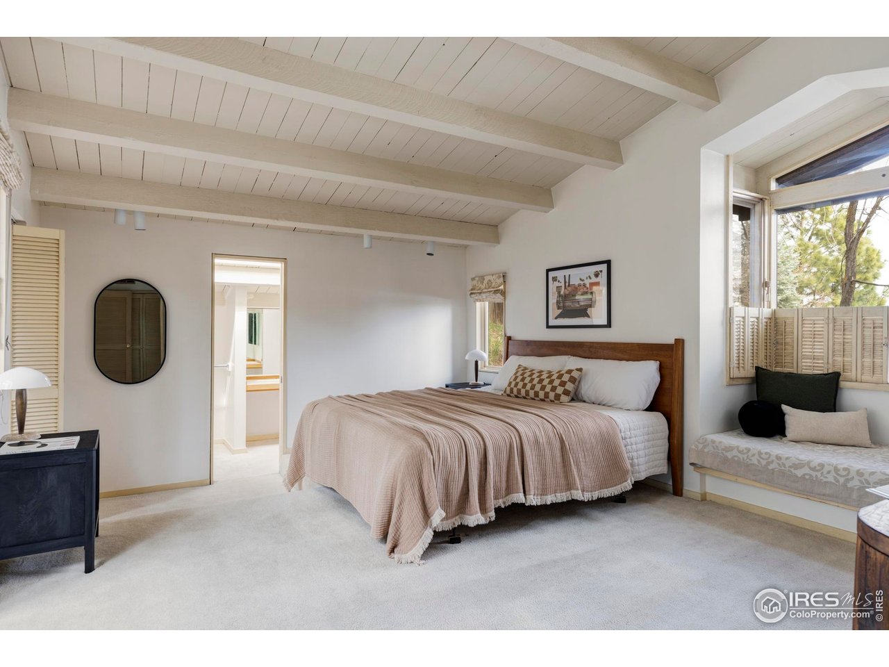 705 Willowbrook Road Boulder, CO 80302 - Photo 25 of 34 a bedroom with a bed a mirror and a window