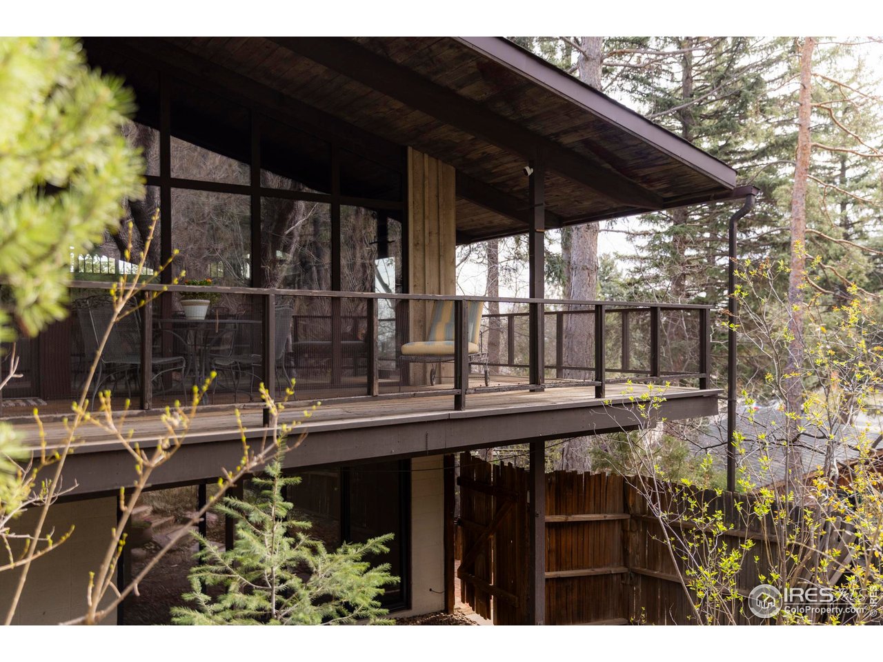 705 Willowbrook Road Boulder, CO 80302 - Photo 29 of 34 a view of backyard with a table and chairs under an umbrella with a small yard