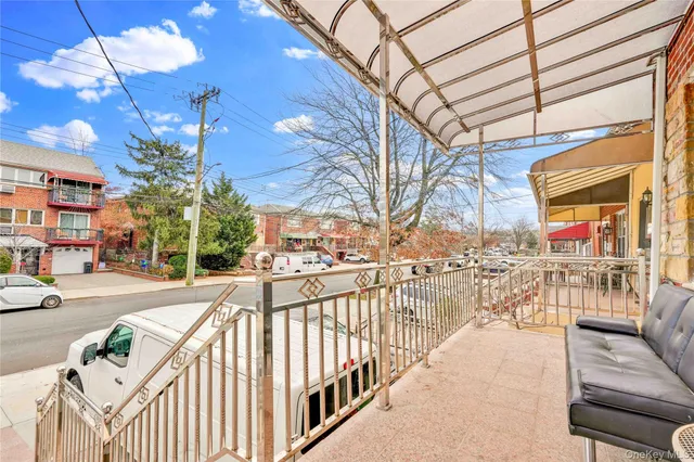 a view of a balcony with couches and wooden floor