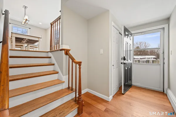 a view of entryway and hall with wooden floor