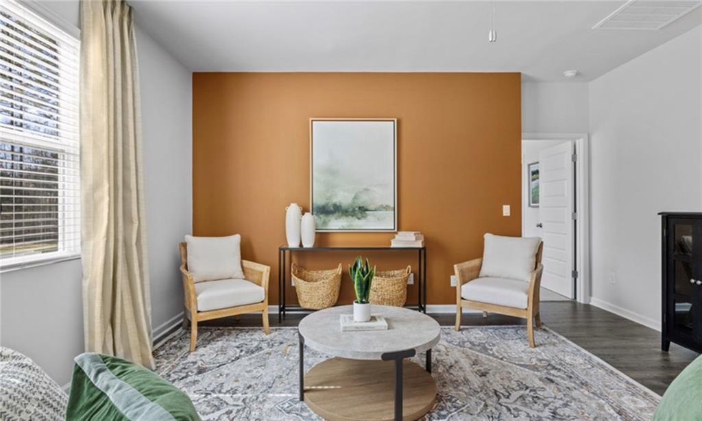 205 Storm Lane Hoschton, GA 30548 - Photo 19 of 51 a living room with furniture and a rug