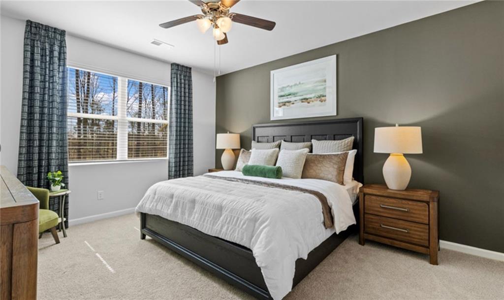 205 Storm Lane Hoschton, GA 30548 - Photo 21 of 51 a spacious bedroom with a bed and window