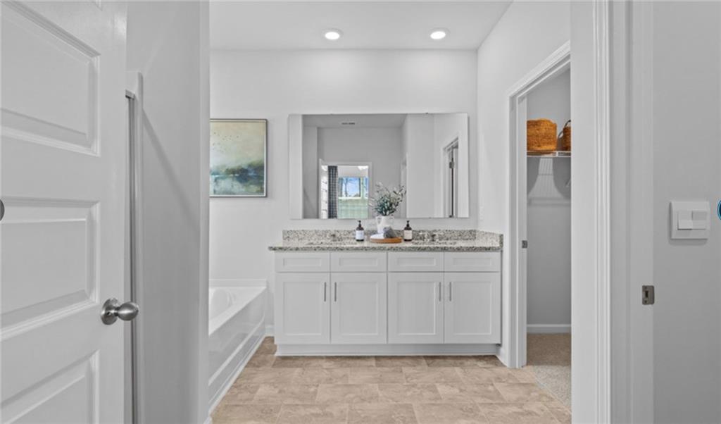 205 Storm Lane Hoschton, GA 30548 - Photo 24 of 51 a bathroom with a sink and a mirror