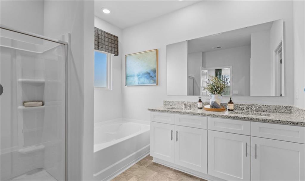 205 Storm Lane Hoschton, GA 30548 - Photo 25 of 51 a bathroom with a tub sink and mirror