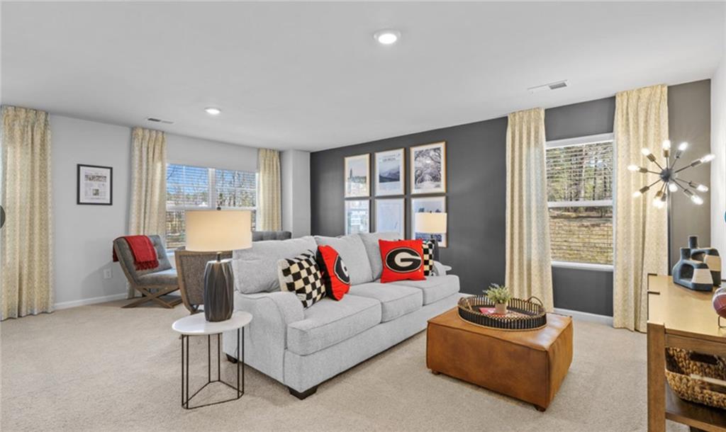 205 Storm Lane Hoschton, GA 30548 - Photo 31 of 51 a living room with furniture and a couch