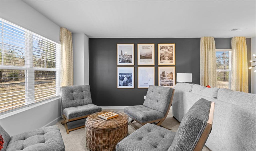 205 Storm Lane Hoschton, GA 30548 - Photo 33 of 51 a living room with furniture and a large window