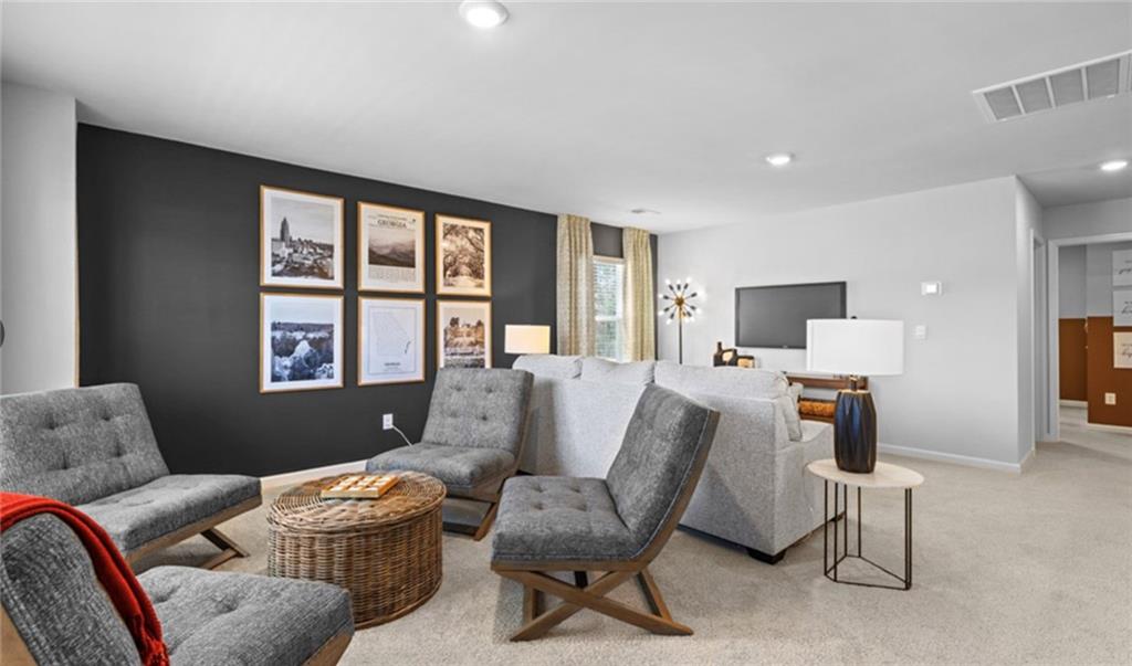 205 Storm Lane Hoschton, GA 30548 - Photo 34 of 51 a living room with furniture and a flat screen tv