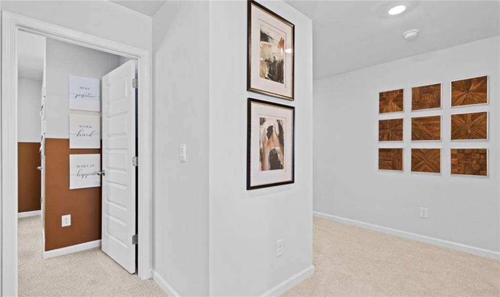 205 Storm Lane Hoschton, GA 30548 - Photo 36 of 51 a view of a hallway with wooden floor and cabinet