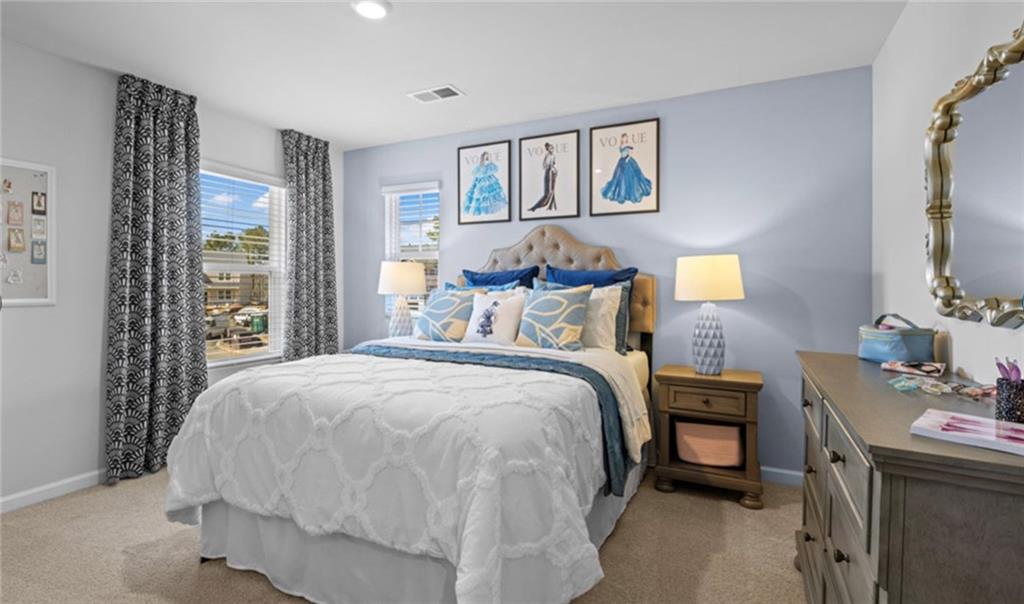 205 Storm Lane Hoschton, GA 30548 - Photo 38 of 51 a bed sitting in a bedroom next to a window