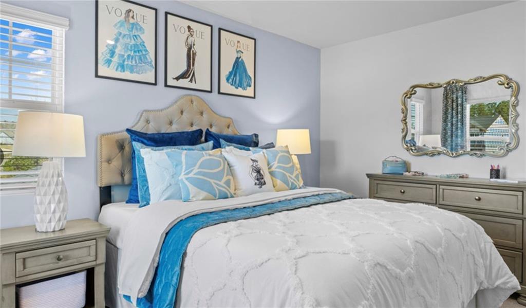 205 Storm Lane Hoschton, GA 30548 - Photo 39 of 51 a bedroom with a bed and a table