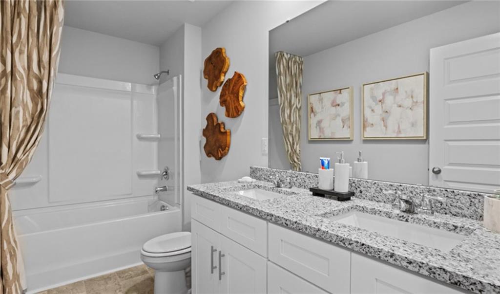 205 Storm Lane Hoschton, GA 30548 - Photo 41 of 51 a bathroom with a granite countertop sink and a mirror