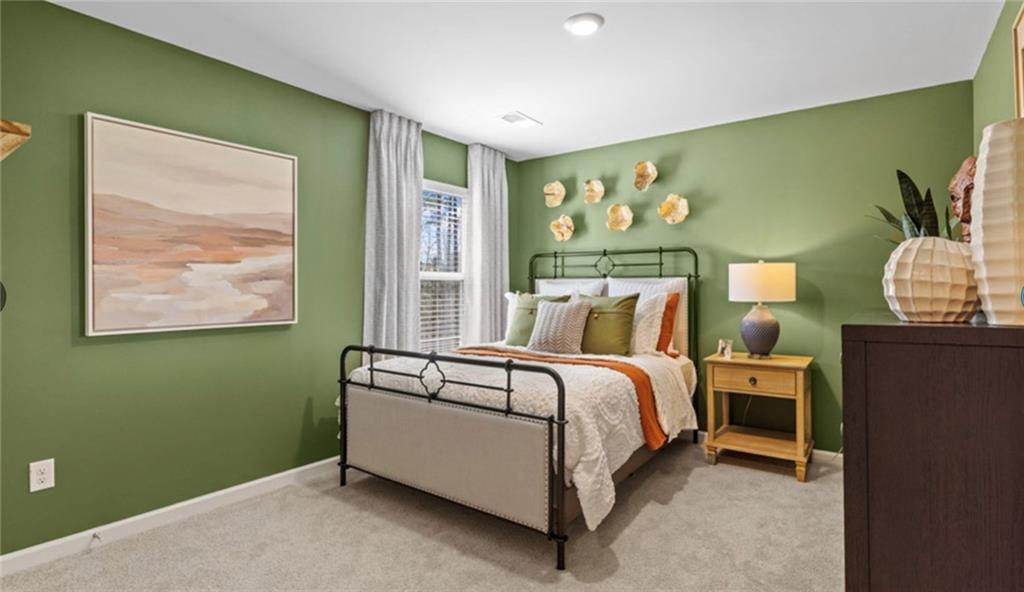 205 Storm Lane Hoschton, GA 30548 - Photo 42 of 51 a bedroom with a bed lamp and a window