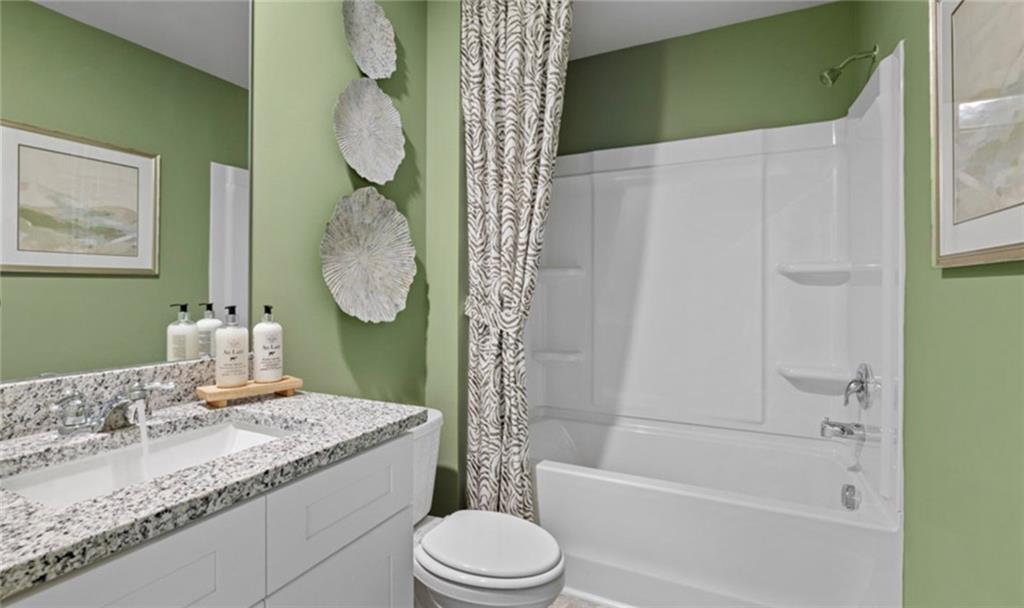 205 Storm Lane Hoschton, GA 30548 - Photo 44 of 51 a bathroom with a granite countertop toilet sink and mirror