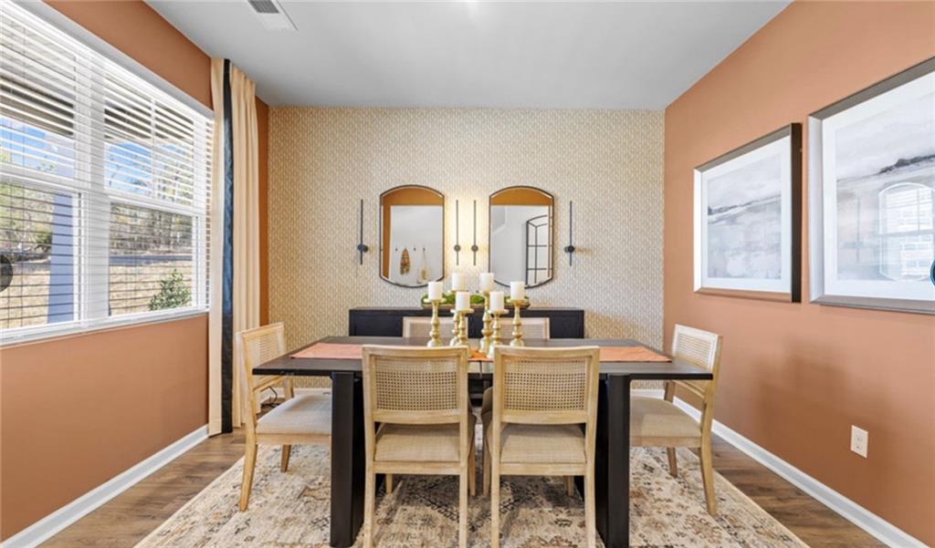 205 Storm Lane Hoschton, GA 30548 - Photo 48 of 51 a view of a dining room with furniture window and outside view