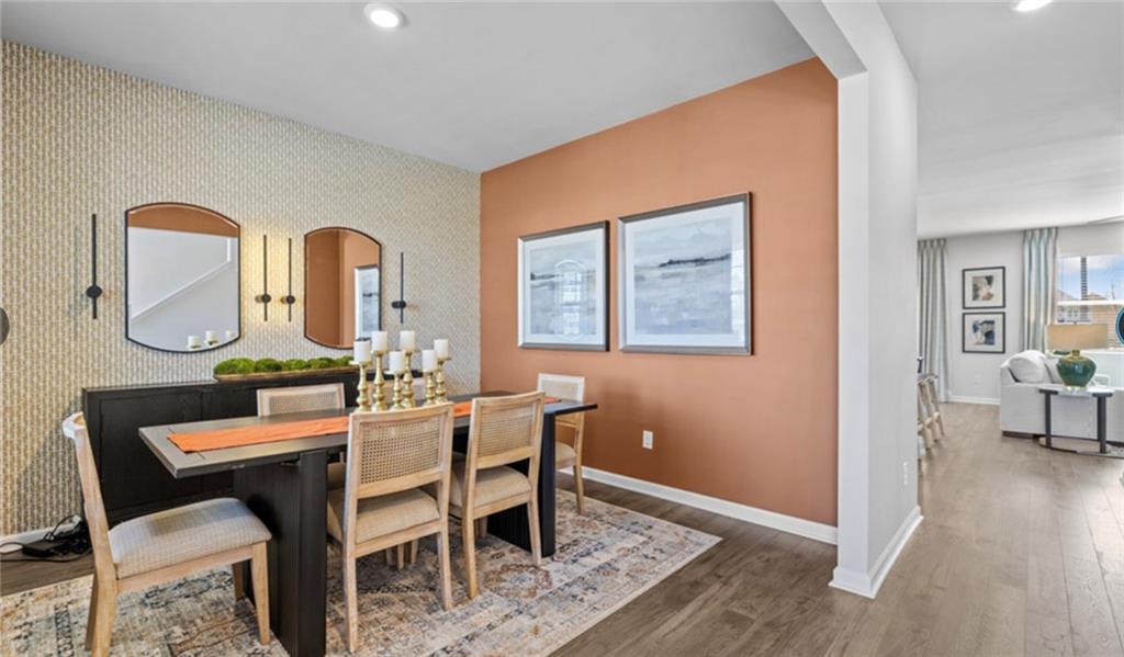 205 Storm Lane Hoschton, GA 30548 - Photo 49 of 51 a dining room with furniture and wooden floor
