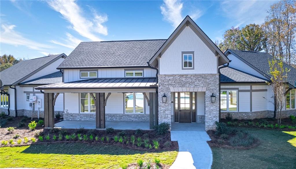 205 Storm Lane Hoschton, GA 30548 - Photo 6 of 51 a front view of a house with a yard outdoor seating and garage