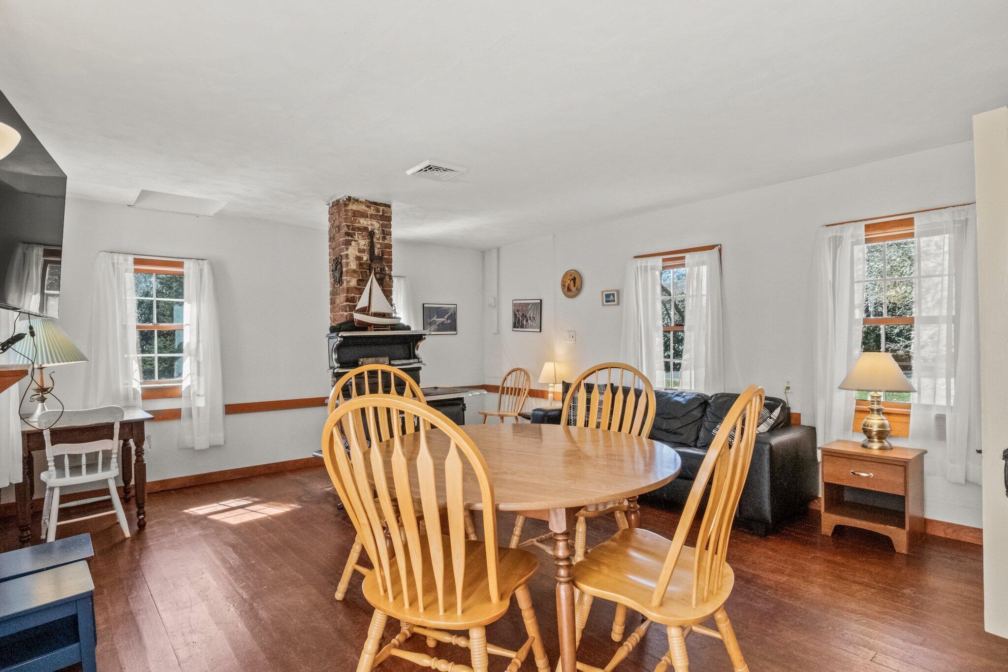 153 Long Road Harwich Port, MA 02646 - Photo 14 of 44 a view of a dining room with furniture and wooden floor