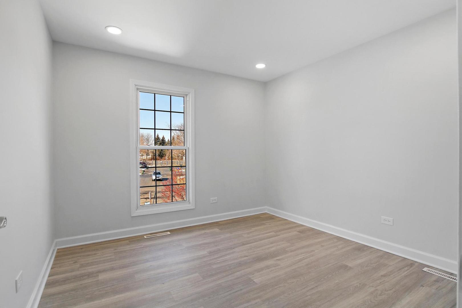 126 West Golf Road, Unit C Libertyville, IL 60048 - Photo 14 of 21 wooden floor in an empty room with a window