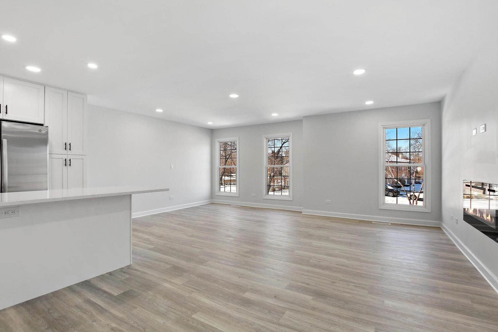 126 West Golf Road, Unit C Libertyville, IL 60048 - Photo 5 of 21 an empty room with wooden floor and windows