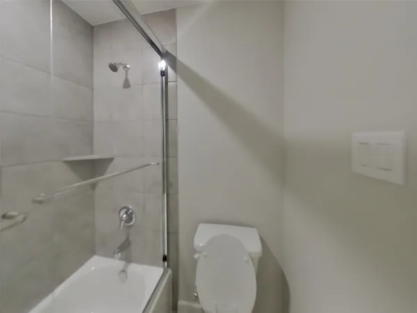a bathroom with a toilet and shower