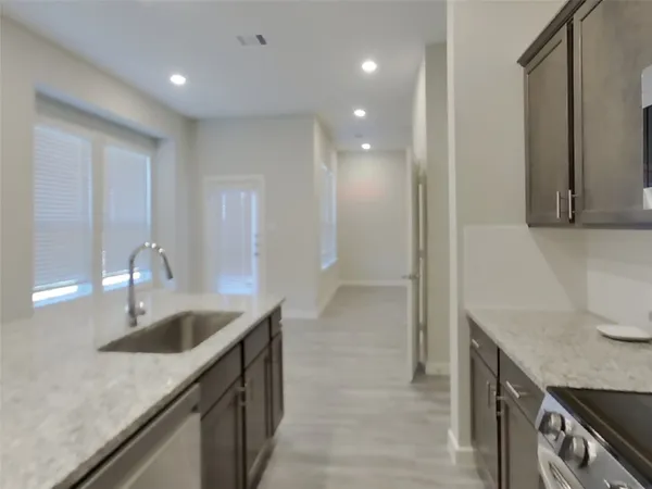a kitchen with sink cabinets and stove