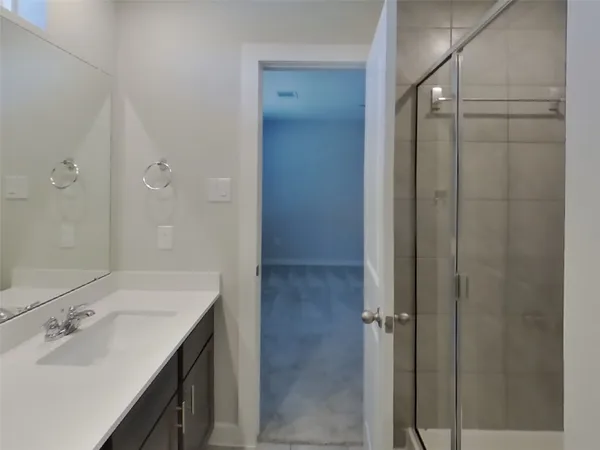 a bathroom with a shower and a sink