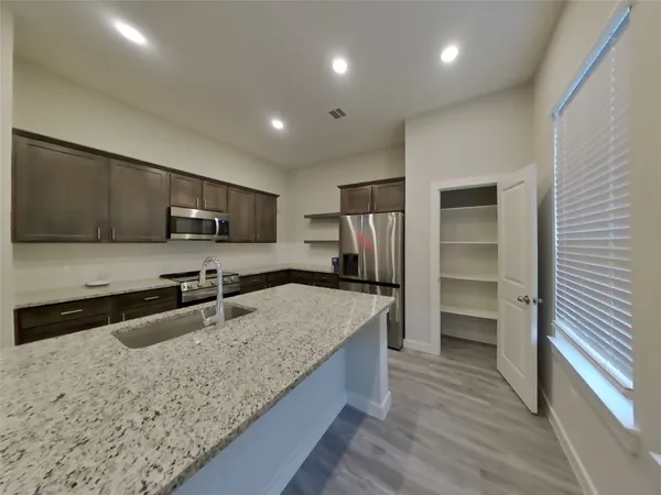 a kitchen with a center island and stainless steel appliances