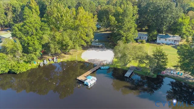 an aerial view of a house with a yard and lake view
