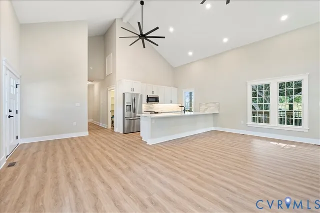 an empty room with windows and fireplace