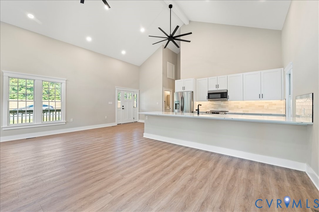 7 Trices Lake Road Columbia, VA 23038 - Photo 25 of 44 a large kitchen with stainless steel appliances a large counter top a wooden floor and a window