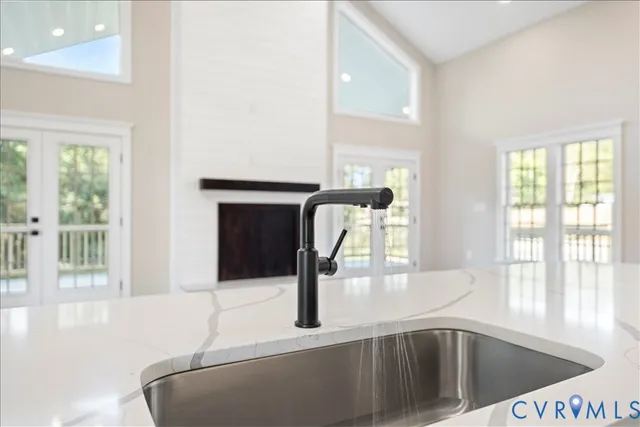 a kitchen with stainless steel appliances white cabinets and wooden floor