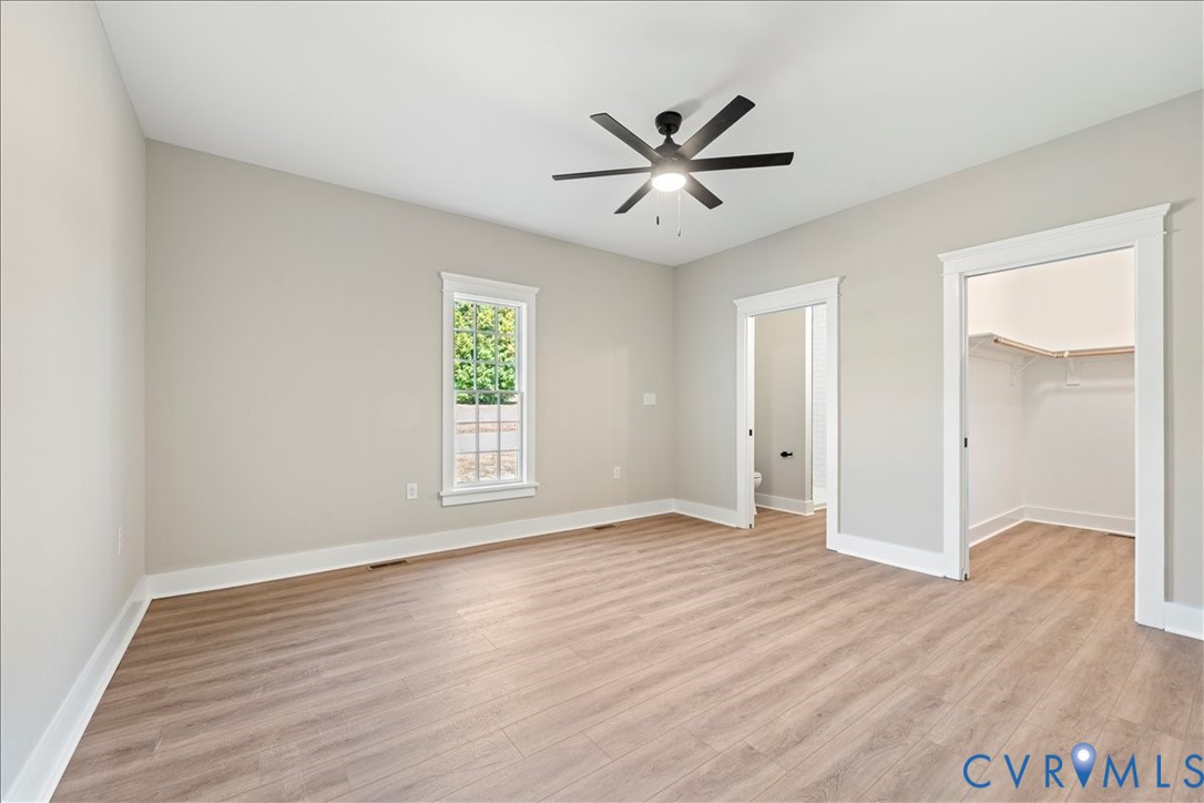 7 Trices Lake Road Columbia, VA 23038 - Photo 35 of 44 a view of an empty room with wooden floor and a window