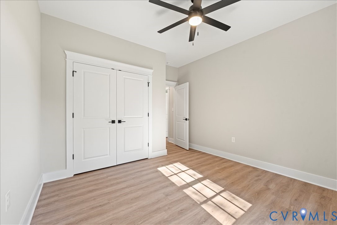 7 Trices Lake Road Columbia, VA 23038 - Photo 42 of 44 an empty room with wooden floor closet and windows