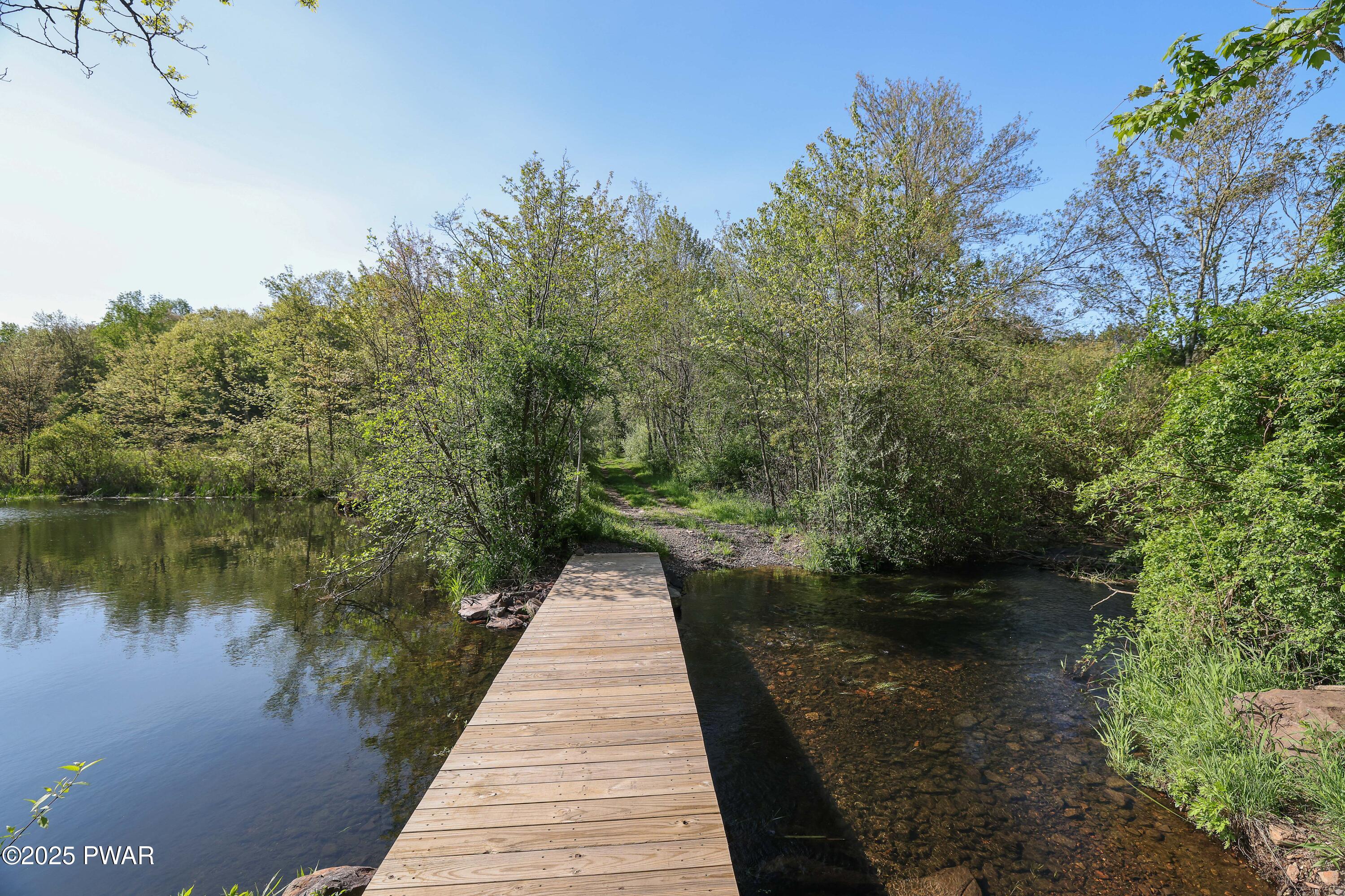 555 Valley View Road Dallas, PA 18612 - Photo 14 of 99 a lake view with a wooden fence