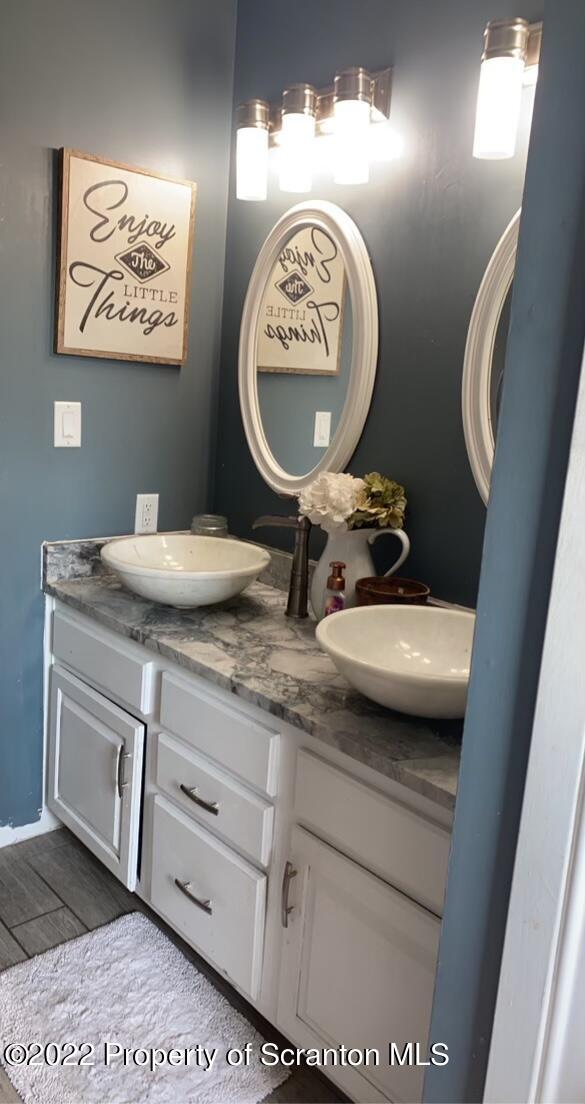 915 Line Road Lake Ariel, PA 18436 - Photo 17 of 17 a bathroom with a granite countertop toilet sink and mirror