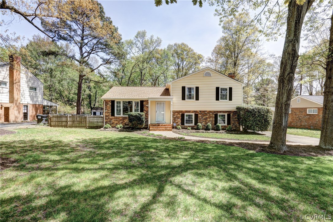1519 Village Grove Road Henrico, VA 23238 - Photo 1 of 36 a front view of a house with a yard and trees