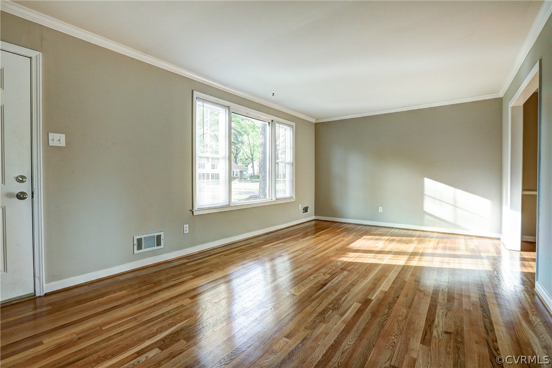 1519 Village Grove Road Henrico, VA 23238 - Photo 9 of 36 a view of an empty room with wooden floor and a window