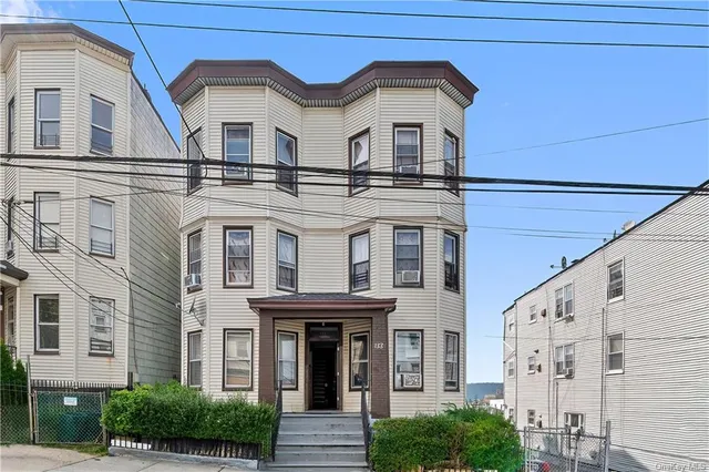 a view of a white building with large windows