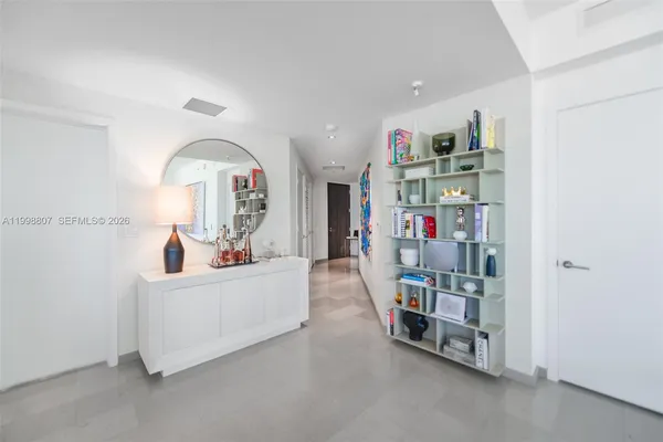 a living room with lots of furniture and a book shelf