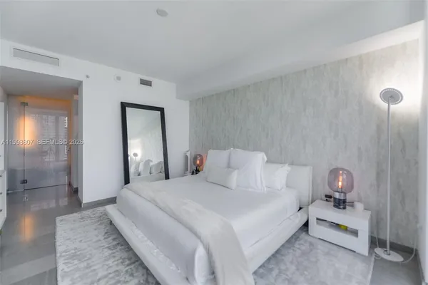 a bedroom with a bed and a table