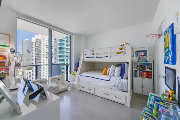 a bedroom with furniture and a baby crib