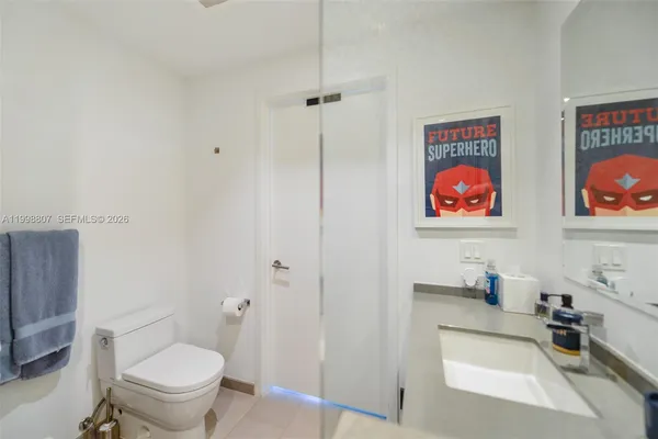 a bathroom with a toilet a sink and a mirror