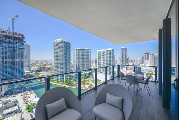 a balcony with furniture and a floor to ceiling window